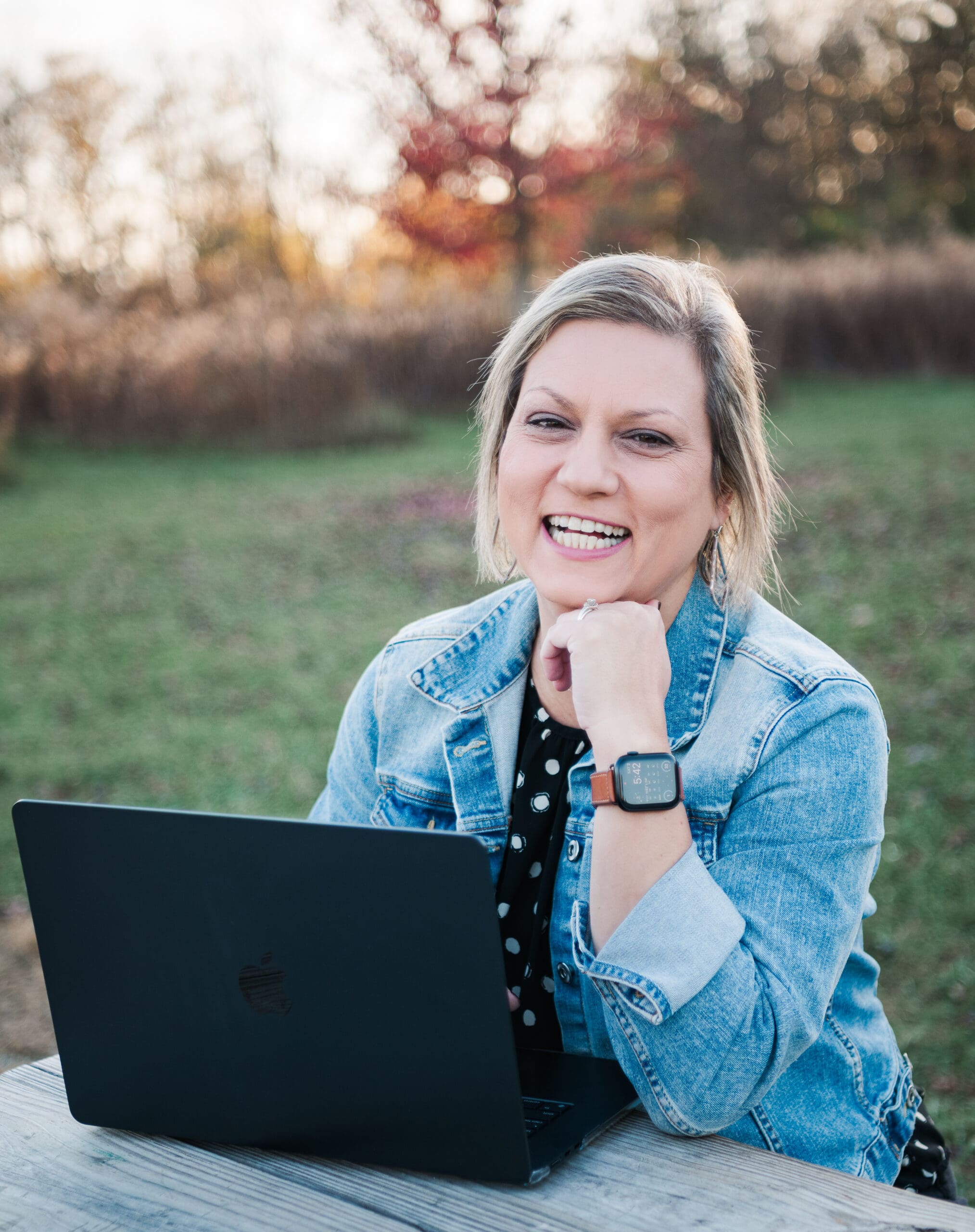 woman working on a laptop happily 