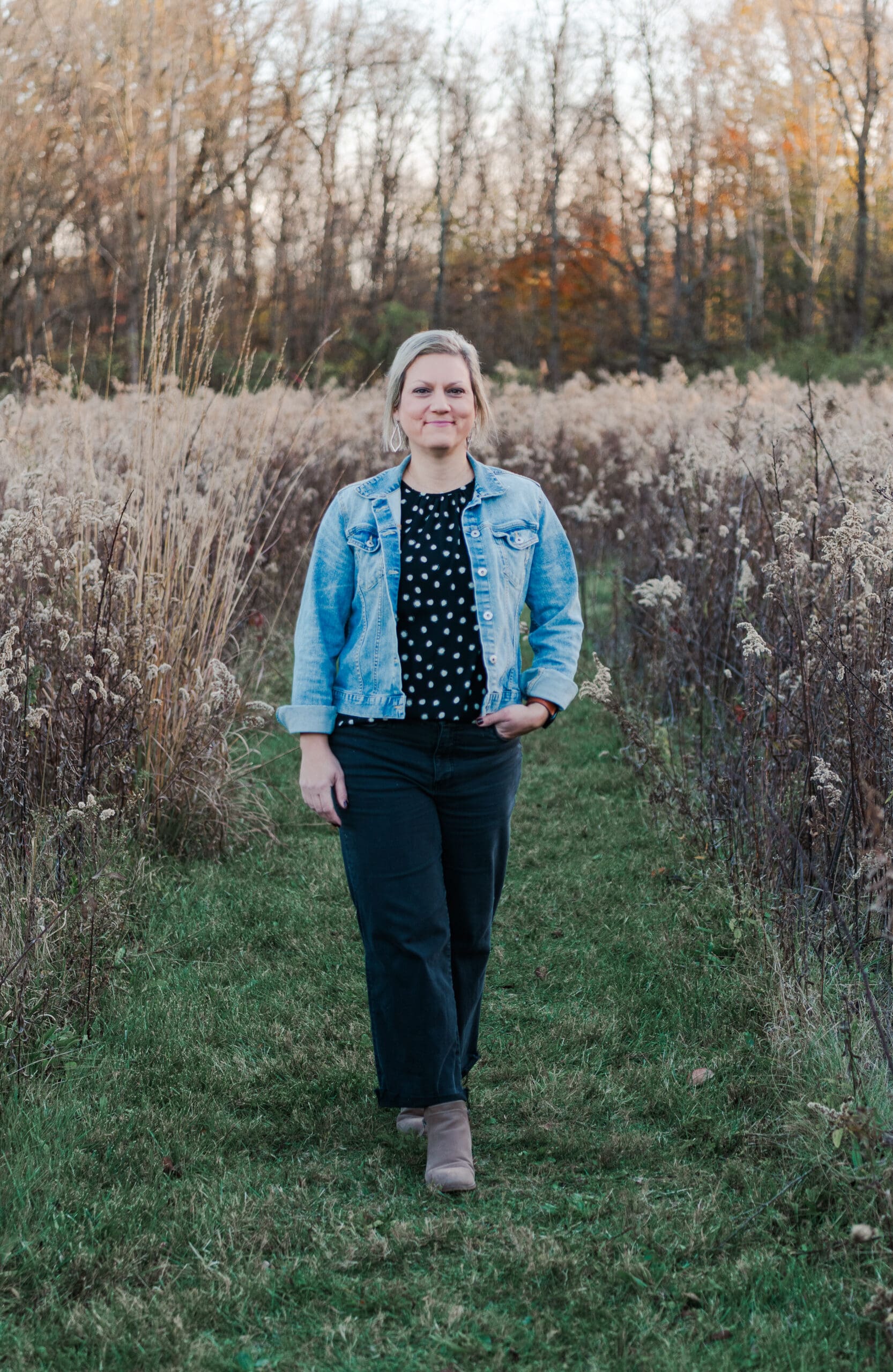 woman walking down through a field at park during golden hour in centerville Ohio