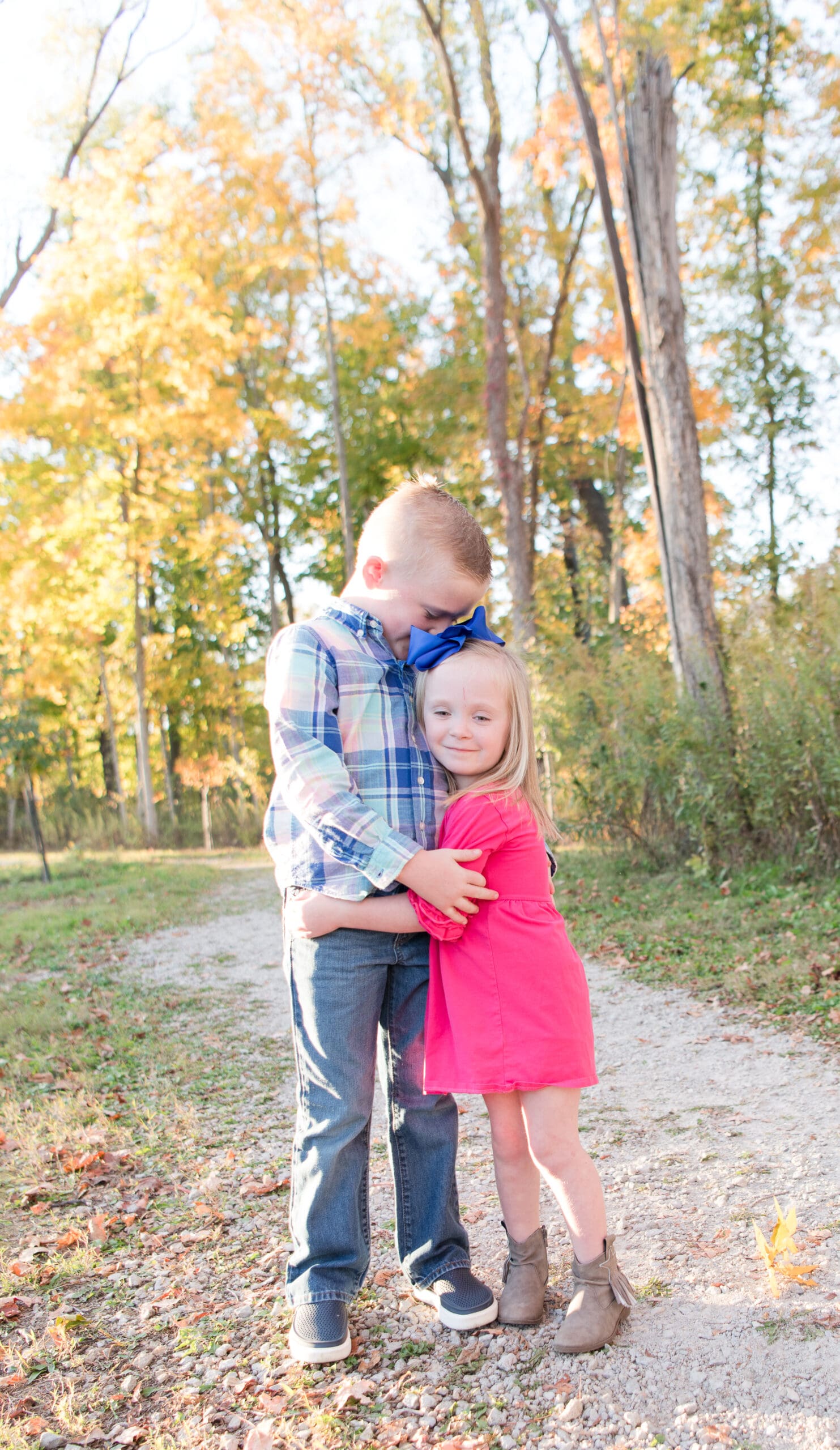 Two kids hugging and looking at local Dayton Ohio photographer